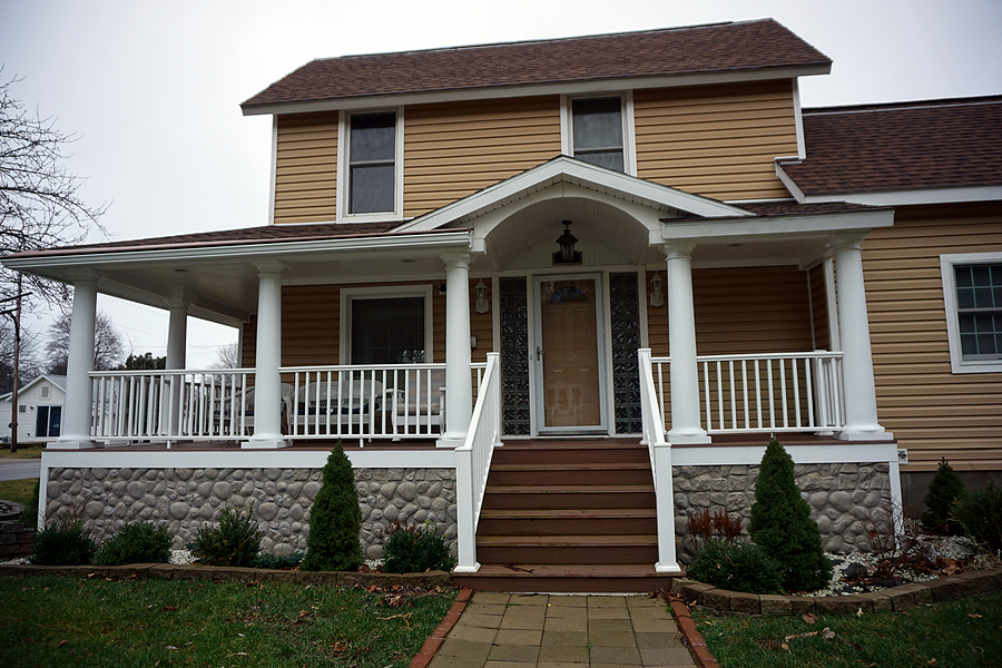 Large front porch with steps and nice walkway leading up to it. New storm door on the front door and nice landscaping.