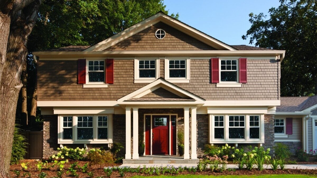 A home with new siding and a freshly installed roof, showcasing a significant improvement in curb appeal in Northwest Ohio.